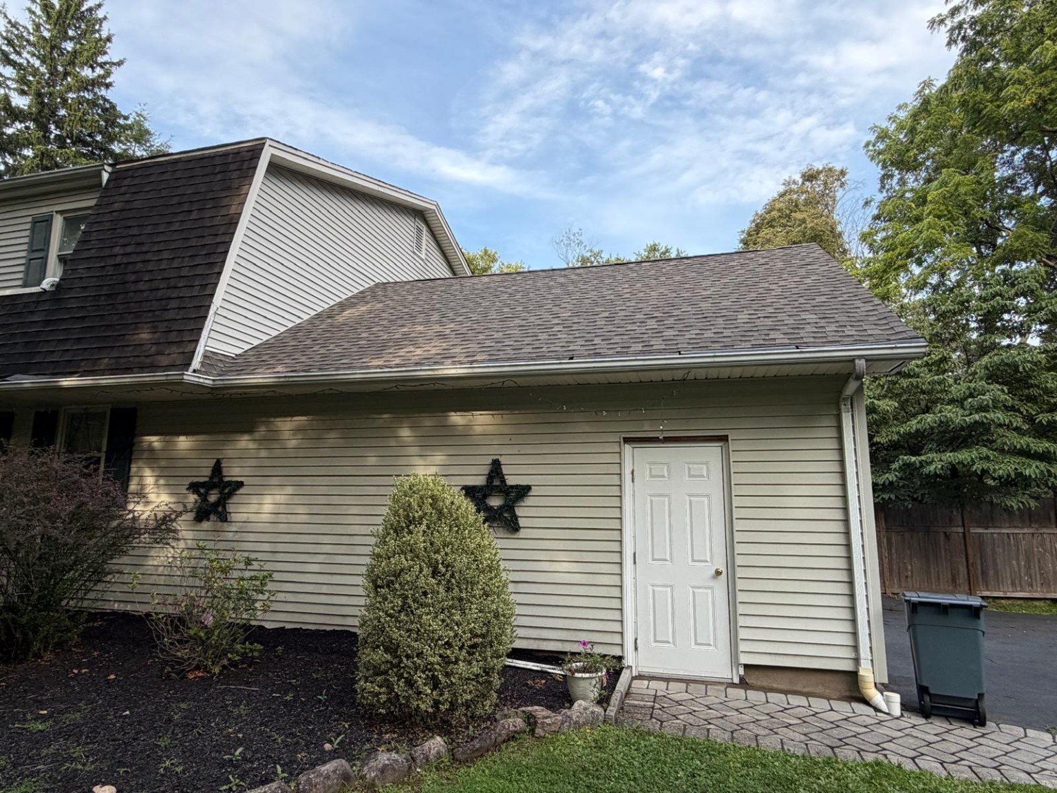 Clean side exterior wall and entry door after exterior surface cleaning.