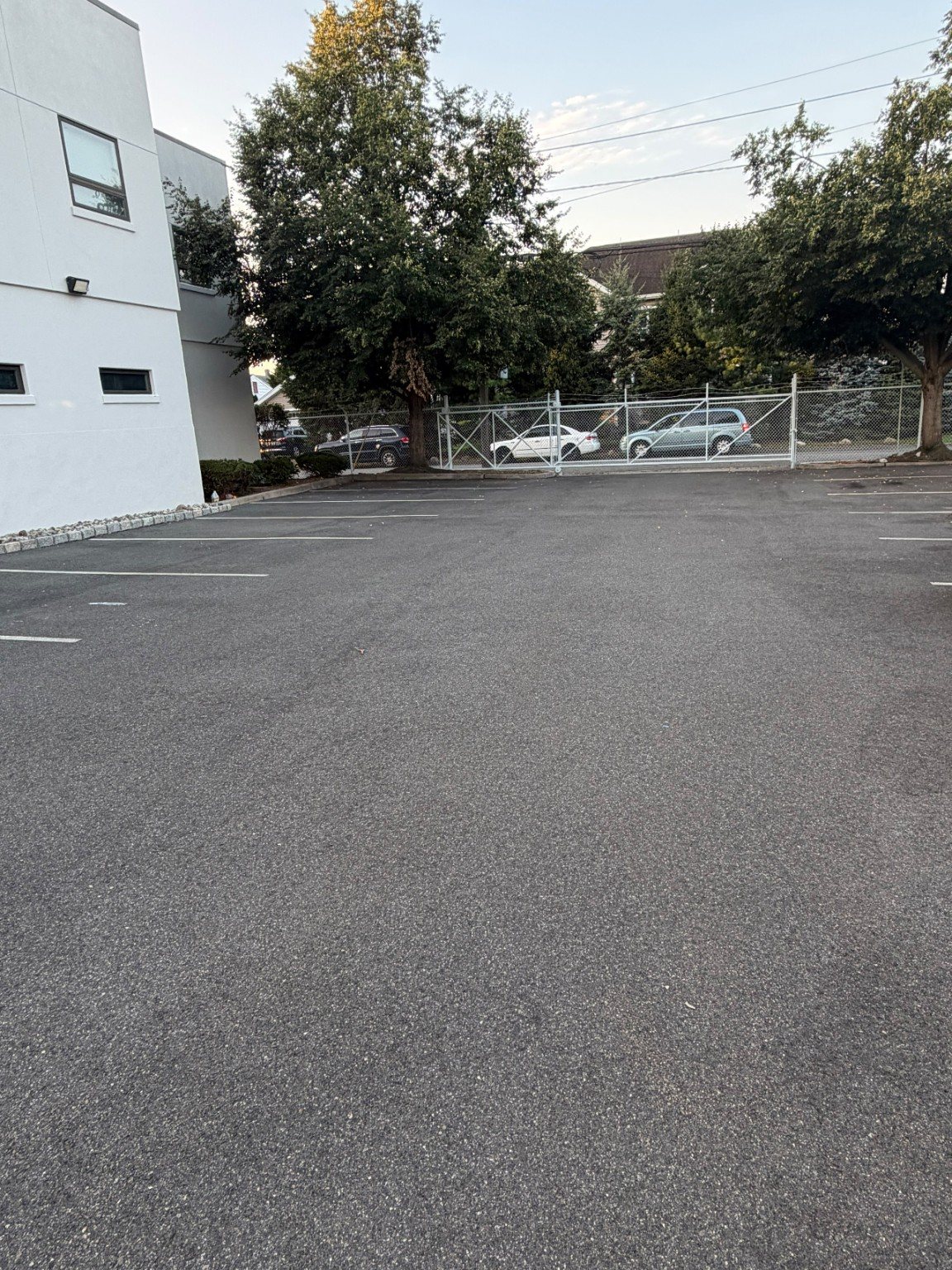 Wide view of the commercial parking lot before surface work.